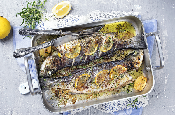 Roasted Bass fish with bay leaves and lemon.